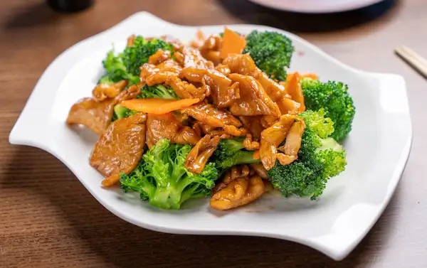 Beef and broccoli stir-fry on a white plate
